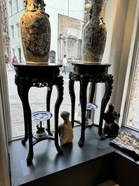 A pair of tall Chinese carved wooden stands with marble tops, 19th C.