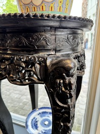 A pair of tall Chinese carved wooden stands with marble tops, 19th C.