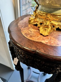 A pair of tall Chinese carved wooden stands with marble tops, 19th C.