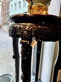 A pair of tall Chinese carved wooden stands with marble tops, 19th C.