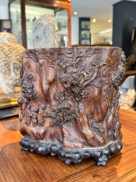 A large Chinese carved huanghuali wooden brush pot with Taoist design, 17/18th C.