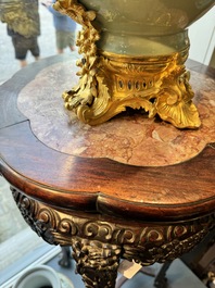 A pair of tall Chinese carved wooden stands with marble tops, 19th C.