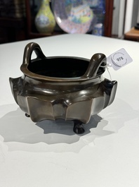 A Chinese bronze lotus-shaped tripod censer, Xuande mark, 18/19th C.