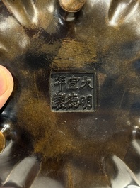 A Chinese bronze lotus-shaped tripod censer, Xuande mark, 18/19th C.