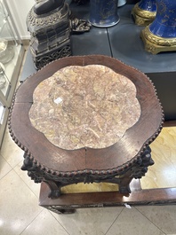 A Chinese carved wooden stand and a low table with marble tops, 19th C.