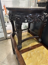 A Chinese carved wooden stand and a low table with marble tops, 19th C.