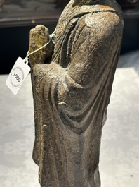 A Chinese gilt cast iron figure of a standing monk, Ming