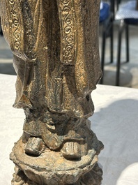 A Chinese gilt cast iron figure of a standing monk, Ming