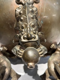 A large Chinese bronze censer and cover on stand decorated with six lions, 19th C.