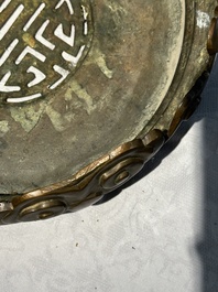 A large Chinese bronze censer and cover on stand decorated with six lions, 19th C.