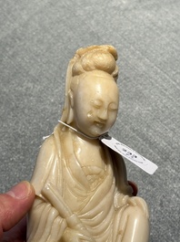 A Chinese soapstone and a crystal figures of Guanyin and a jade 'chilong' plaque, 19th C.