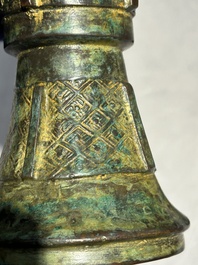 A Chinese bronze Shang-style 'gu' vase on wooden stand, 19/20th C.