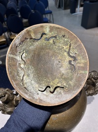 A large Chinese bronze censer and cover on stand decorated with six lions, 19th C.