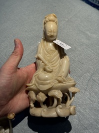 A Chinese soapstone and a crystal figures of Guanyin and a jade 'chilong' plaque, 19th C.