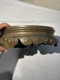 A large Chinese bronze censer and cover on stand decorated with six lions, 19th C.