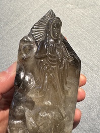 A Chinese soapstone and a crystal figures of Guanyin and a jade 'chilong' plaque, 19th C.