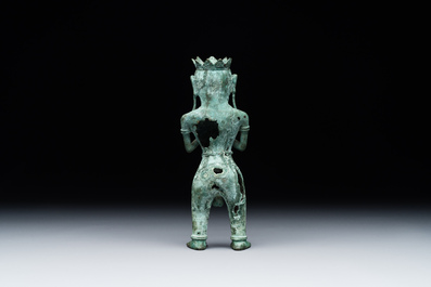 A fine bronze sculpture of a naked man offering a sacrificial vase, Majapahit, East Java, 13/14th C.