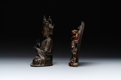 A Chinese bronze Guanyin, Ming and a Tibetan polychrome plaster relief, 19th C.