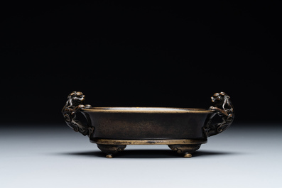 A rare Chinese bronze narcissus basin-shaped censer with dragon handles, Xuande mark, 17th C.