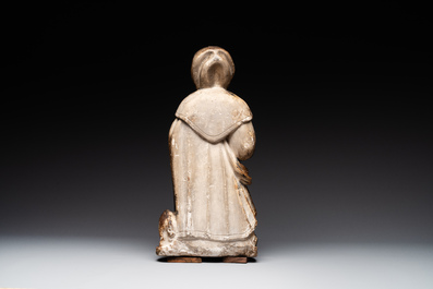 A large Burgundian stone sculpture of Saint Anthony the Great with attributes, France, 14th C.