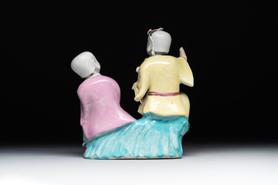 A Chinese famille rose group of Hehe Erxian on wooden stand, Qianlong