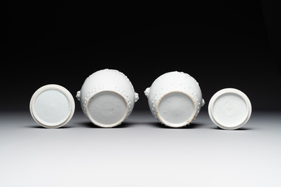 A pair of Chinese Canton famille rose vases and a pair of Dehua blanc de Chine drum-shaped covered jars, 19th C.