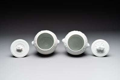 A pair of Chinese Canton famille rose vases and a pair of Dehua blanc de Chine drum-shaped covered jars, 19th C.