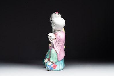 A Chinese famille rose group of Hehe Erxian on wooden stand, Qianlong