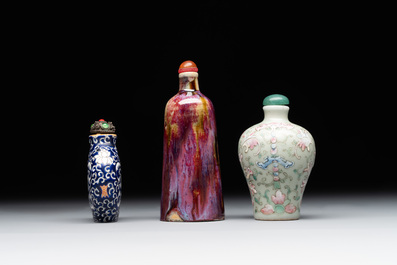 Two Chinese famille rose 'lotus scroll' snuff bottles and a flamb&eacute;-glazed snuff bottle, 19th C.
