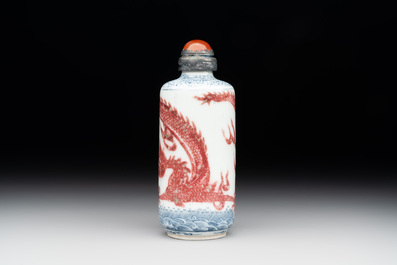 A Chinese blue, white and copper-red snuff bottle with a dragon, dragon mark, 19th C.