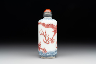 A Chinese blue, white and copper-red snuff bottle with a dragon, dragon mark, 19th C.
