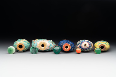 Five Chinese moulded famille rose snuff bottles, Qianlong mark, 19th C.