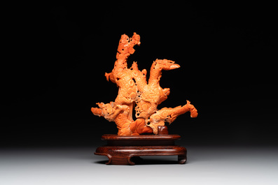 A Chinese red coral group of Shoulao with two boys holding a peach, inscribed 'Shou Bi Nan Shan 壽比南山', 19/20th C.