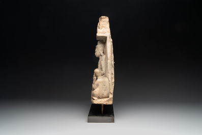 A Burmese limestone stele with Buddha and two attendants with traces of gilding, 19th C.