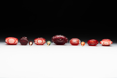 A group of seven Chinese red-overlay glass and red glass snuff bottles, 19/20th C.