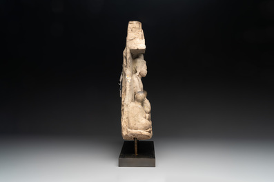 A Burmese limestone stele with Buddha and two attendants with traces of gilding, 19th C.