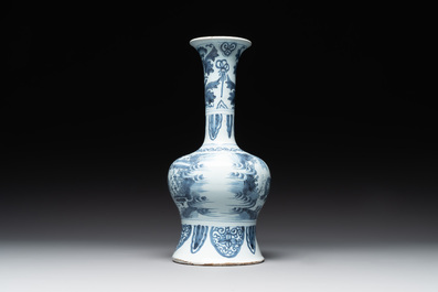 A blue and white Dutch Delft bottle-shaped chinoiserie vase with a lion, 17th C.