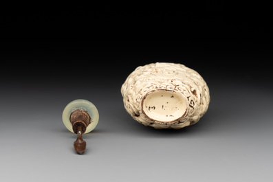A Chinese moulded cream-glazed 'dragon and phoenix' snuff bottle, Jiaqing mark, 19th C.