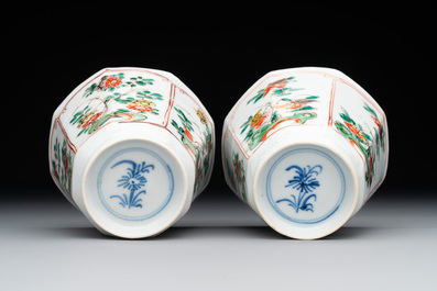 A Chinese wucai rouleau vase and a pair of octagonal cups with floral design, Transitional period/Kangxi