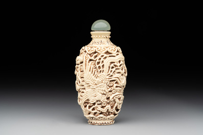 A Chinese moulded cream-glazed 'dragon and phoenix' snuff bottle, Jiaqing mark, 19th C.