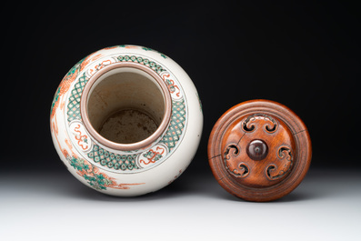 A Chinese famille rose coral-red-ground vase and a famille verte vase, 19th C.