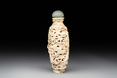 A Chinese moulded cream-glazed 'dragon and phoenix' snuff bottle, Jiaqing mark, 19th C.