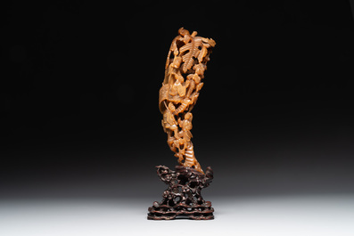 A Chinese buffalo horn carving of a landscape with a pagoda on wooden stand, Qing