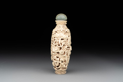 A Chinese moulded cream-glazed 'dragon and phoenix' snuff bottle, Jiaqing mark, 19th C.