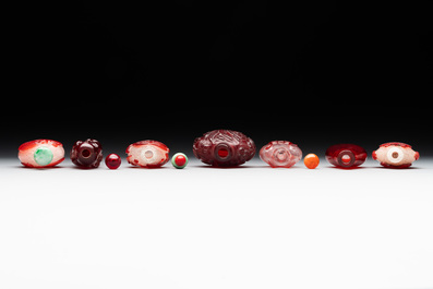 A group of seven Chinese red-overlay glass and red glass snuff bottles, 19/20th C.