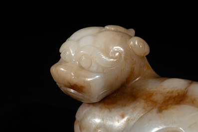 A large Chinese white and russet jade sculpture of a mythical beast, 17/18th C.