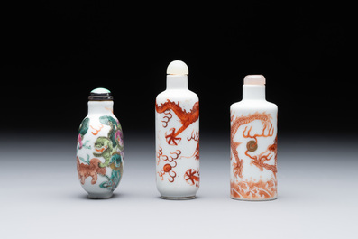 Three Chinese famille rose and iron-red 'Buddhist lion' and 'dragon' snuff bottles, 19th C.