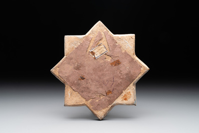An intact Kashan lustre-glazed star tile, Persia, 13/14th C.