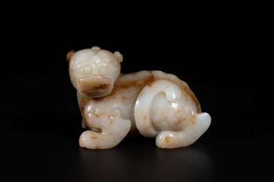 A large Chinese white and russet jade sculpture of a mythical beast, 17/18th C.