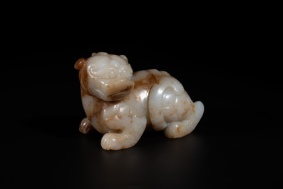 A large Chinese white and russet jade sculpture of a mythical beast, 17/18th C.